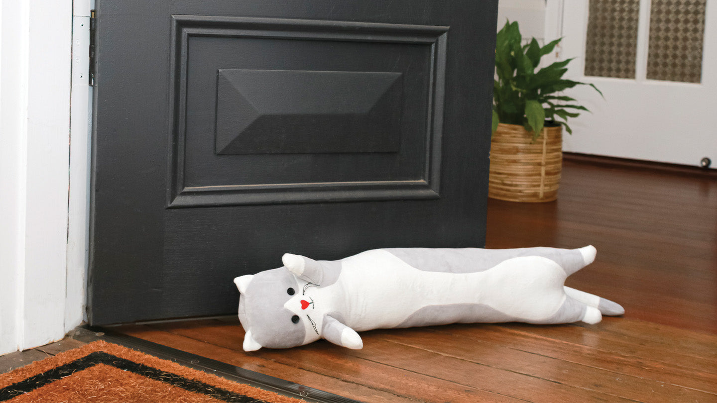 Playful cat doorstop