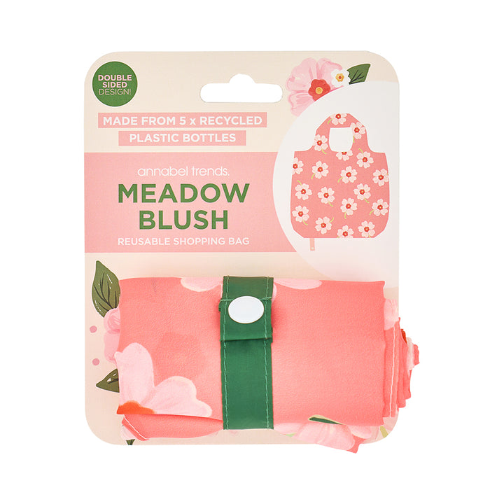 Reusable shopping bag packaging with floral design and text on a white background