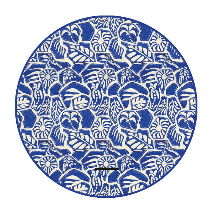Circular blue and white patterned picnic rug on a white background