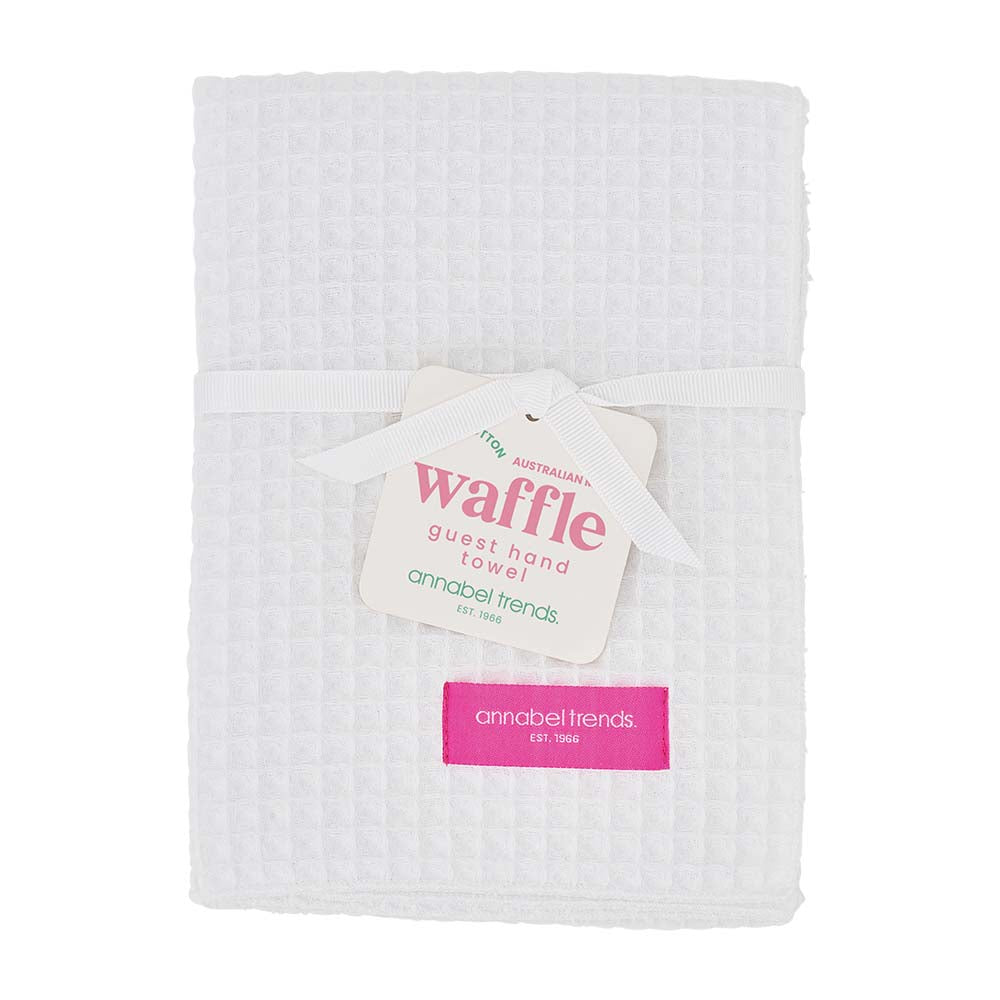 White waffle guest hand towel with a visible brand tag on a white background