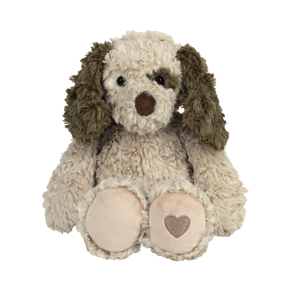 Plush toy dog with brown ears and a heart on its paw on a white background