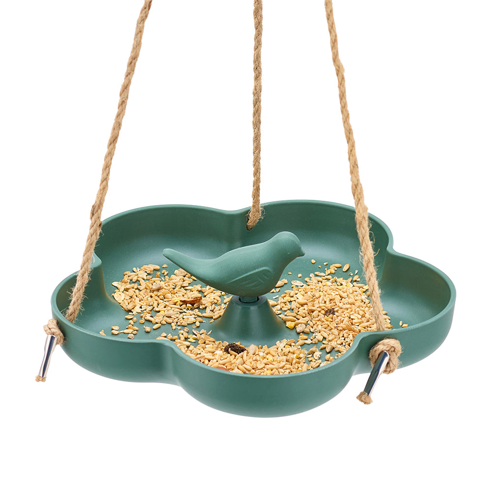 Green bird feeder with a bird figurine and seeds on a white background