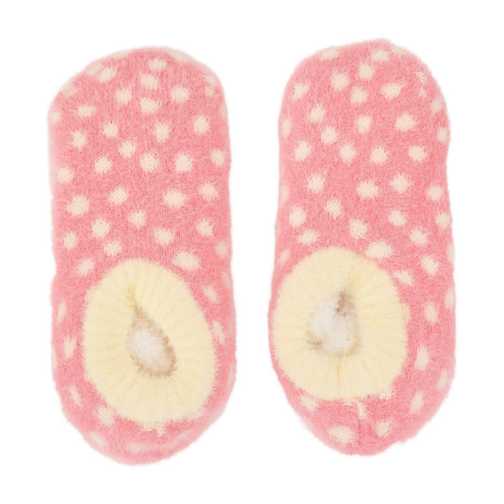 Pair of pink polka dot fuzzy bootie socks on a white background