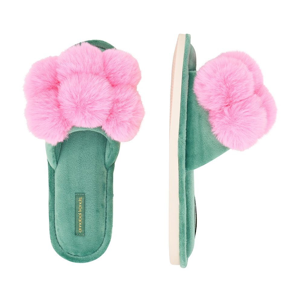 Green slippers with pink fluffy flowers on a white background