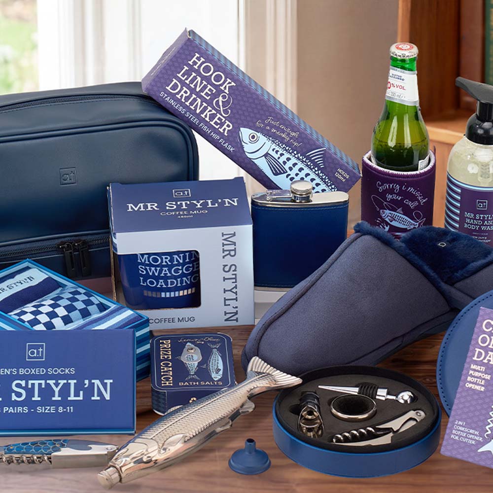 Collection of men's grooming and lifestyle products on a wooden surface with a window in the background.