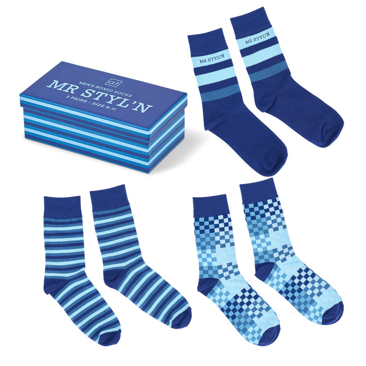 Set of blue and light blue patterned socks with packaging on a white background