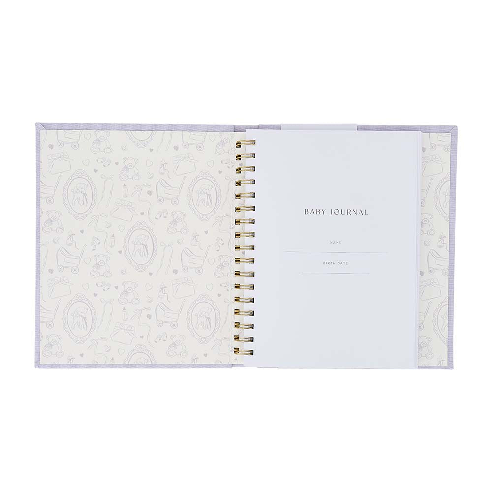 Open baby journal with decorative cover on a white background