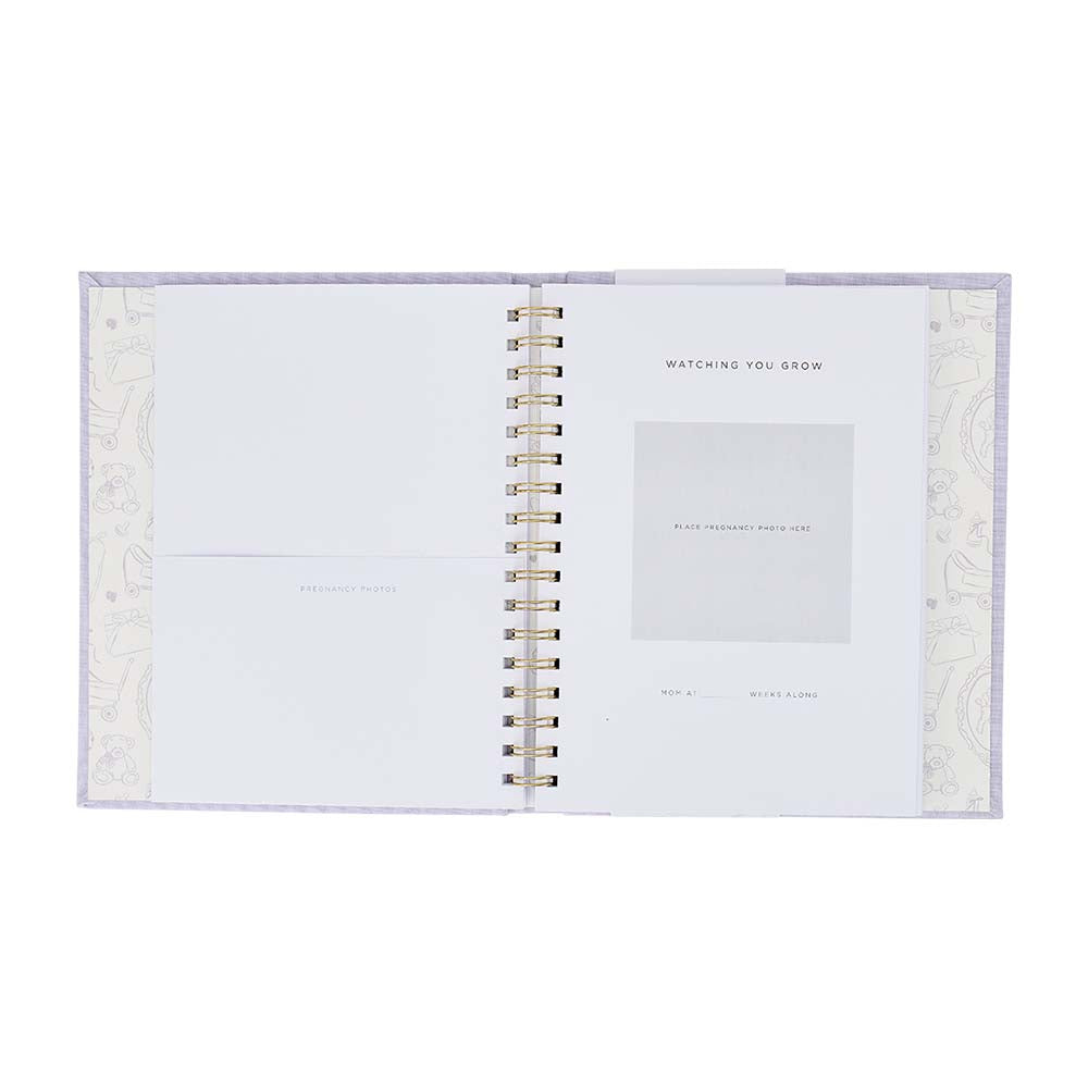 Open spiral-bound notebook with decorative cover on a white background