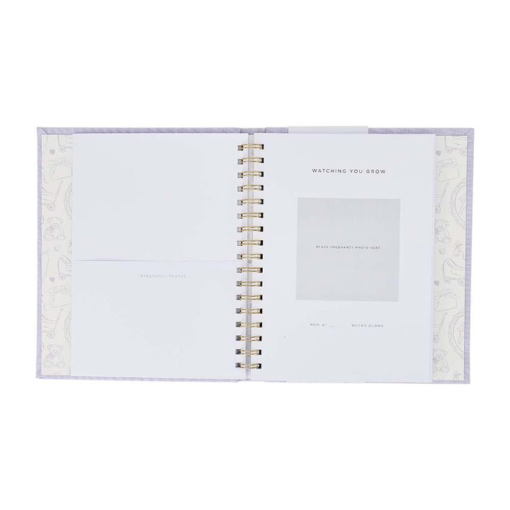 Open spiral-bound notebook with decorative cover on a white background