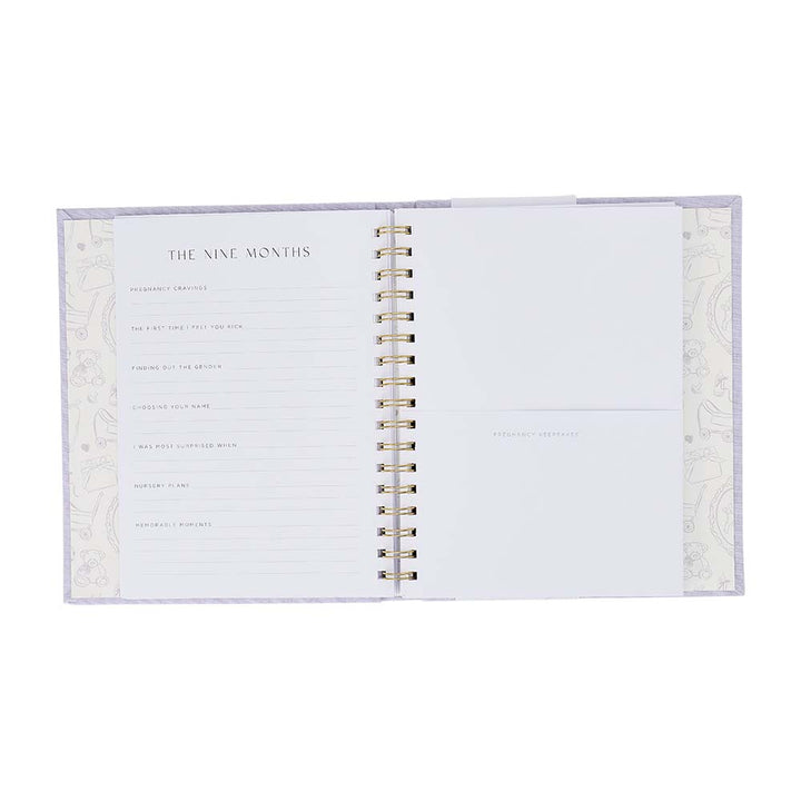 Open spiral-bound notebook with decorative cover on a white background
