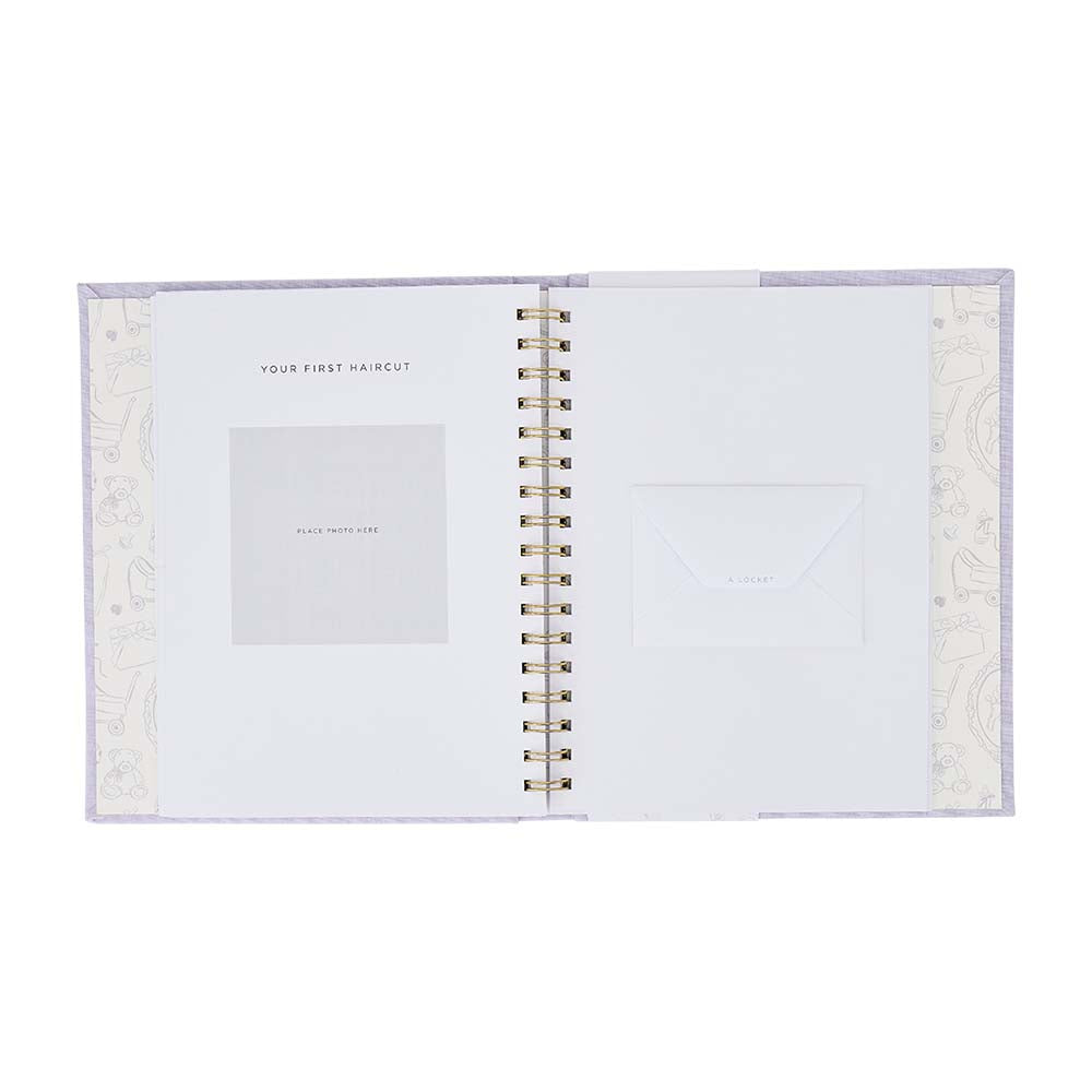 Open spiral-bound notebook with decorative cover on a white background