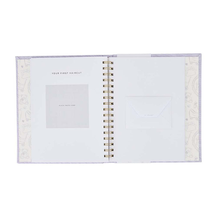 Open spiral-bound notebook with decorative cover on a white background