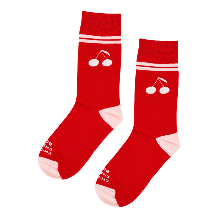 Red socks with cherry design on a white background