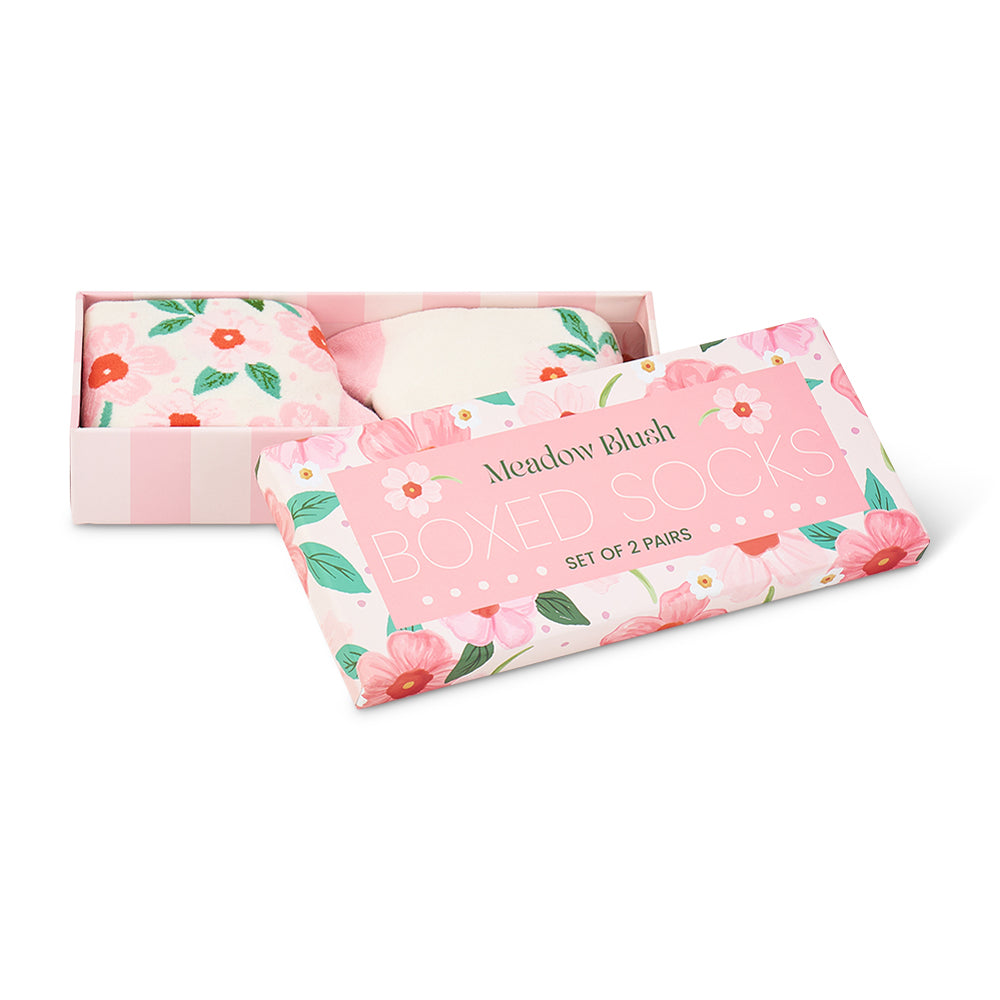 Set of floral-patterned socks in a pink box with 'Meadow Blush' branding.