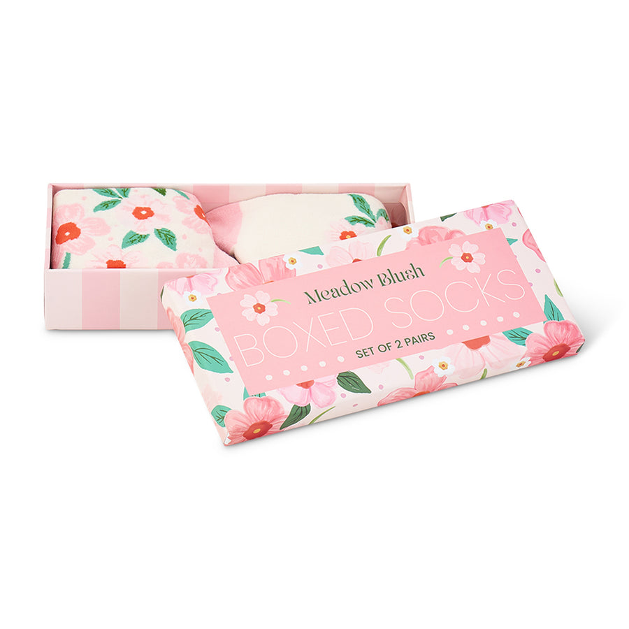 Set of floral-patterned socks in a pink box with 'Meadow Blush' branding.
