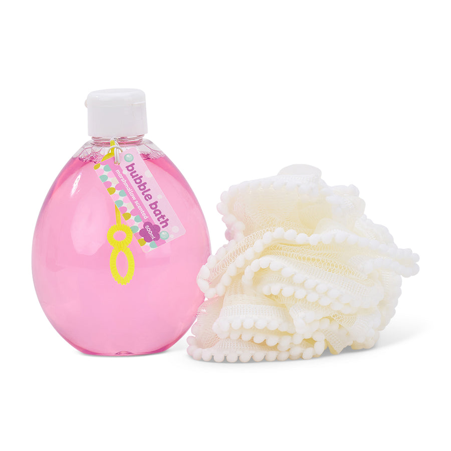 Pink bottle of bubble bath with a white loofah on a white background