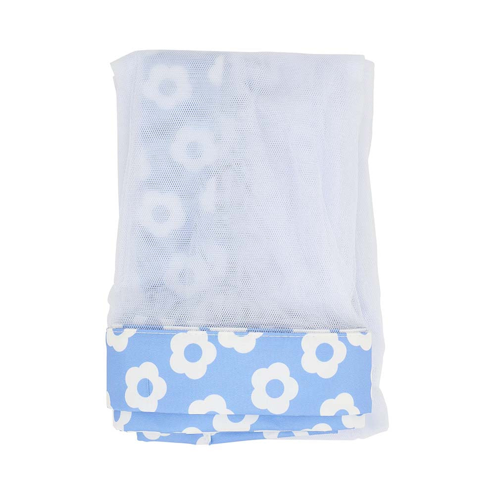 Folded towel with white floral pattern on a light blue background