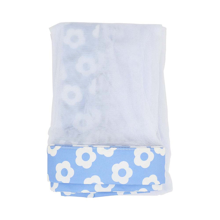 Folded towel with white floral pattern on a light blue background