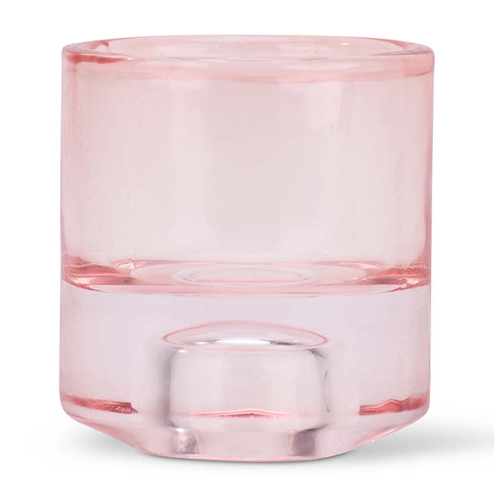 Pink glass candle holder on a white background