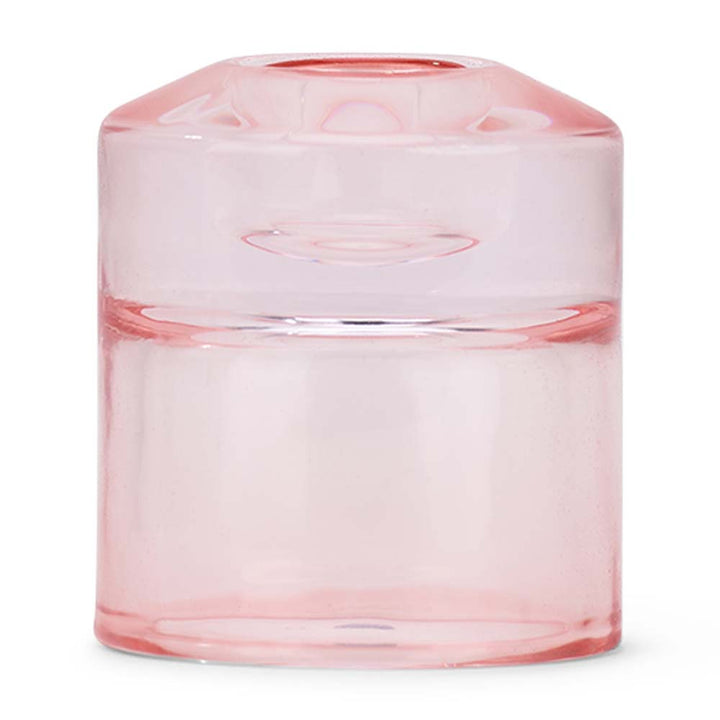 Pink glass candle holder on a white background