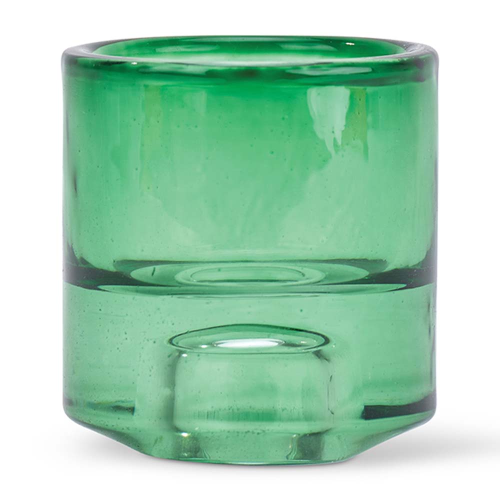 Green glass candle holder on a white background