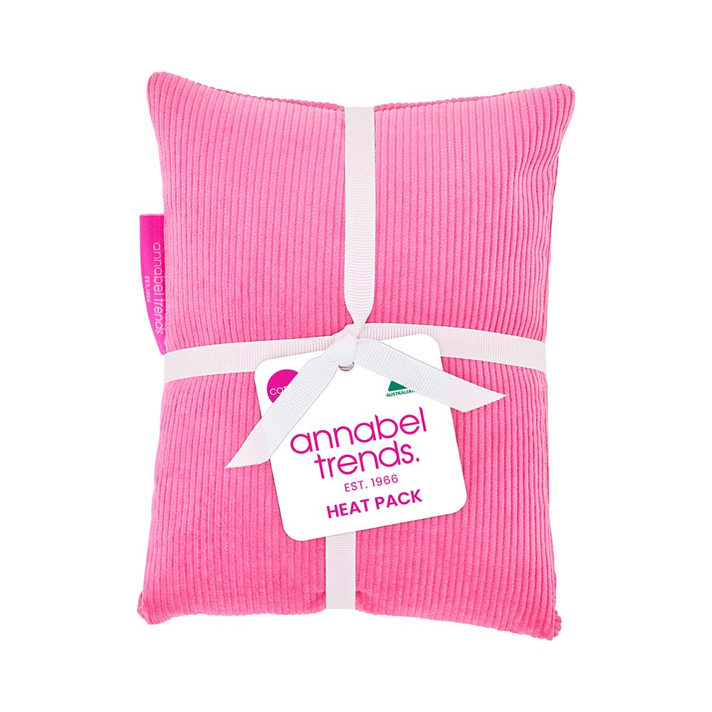 Pink heat pack with a white ribbon and 'annabel trends' tag on a white background