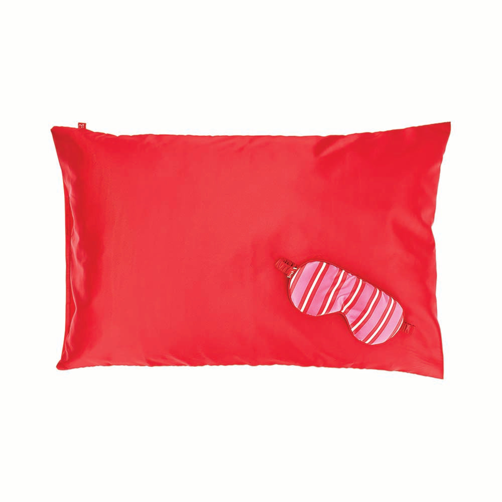 Red pillowcase with a pink striped eye mask on a white background