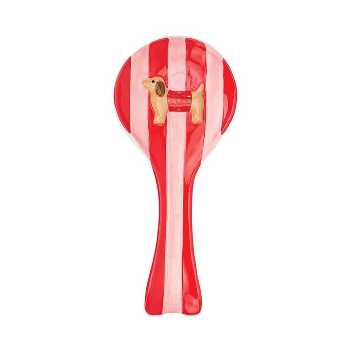 Red and white striped spoon with a dog design on a white background