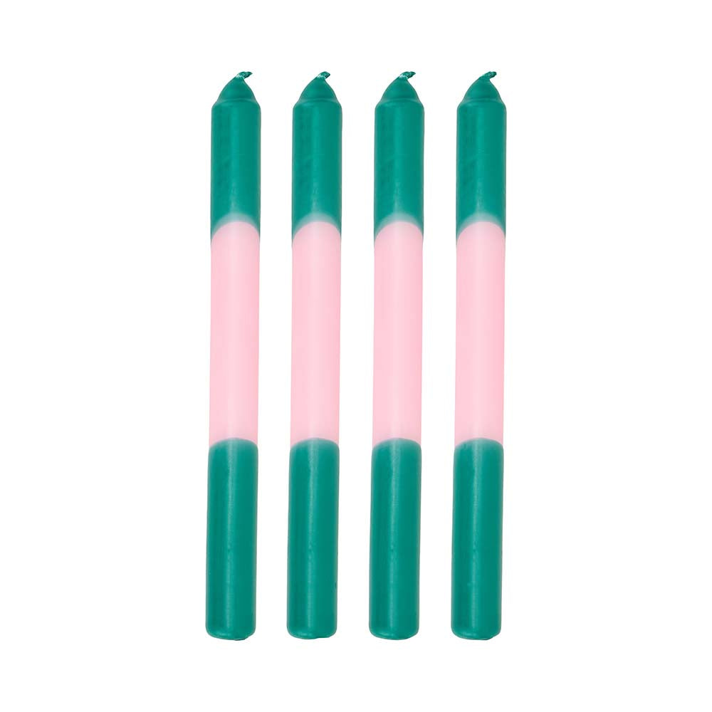 Four teal and pink candles on a white background