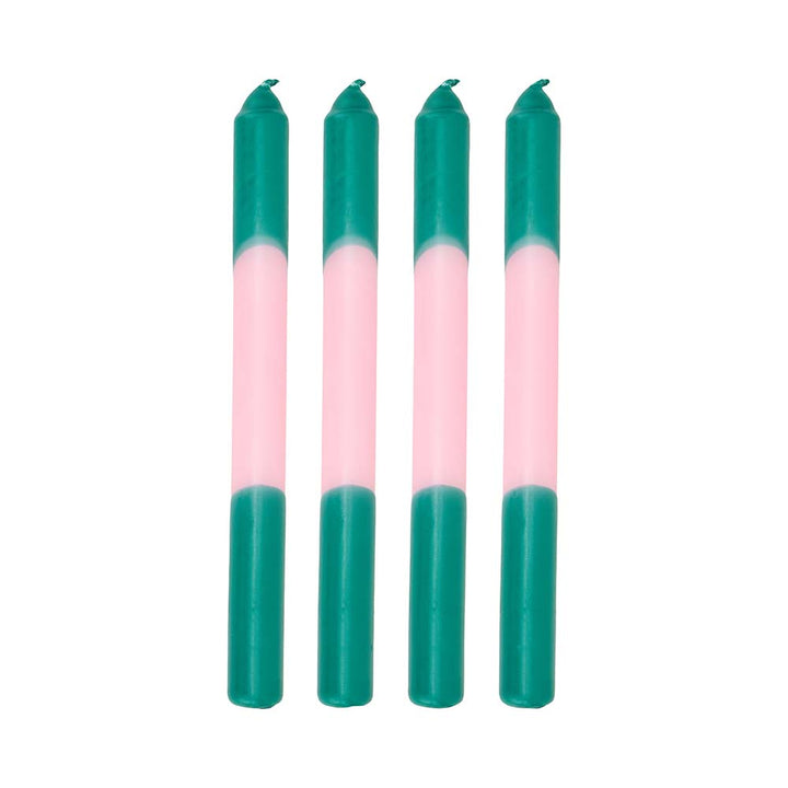 Four teal and pink candles on a white background