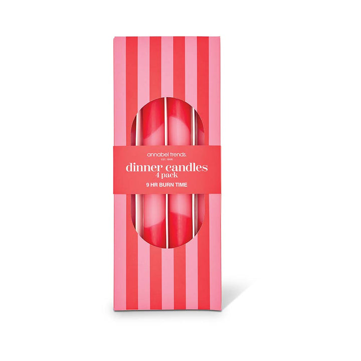 Pack of four red dinner candles in a striped box on a white background