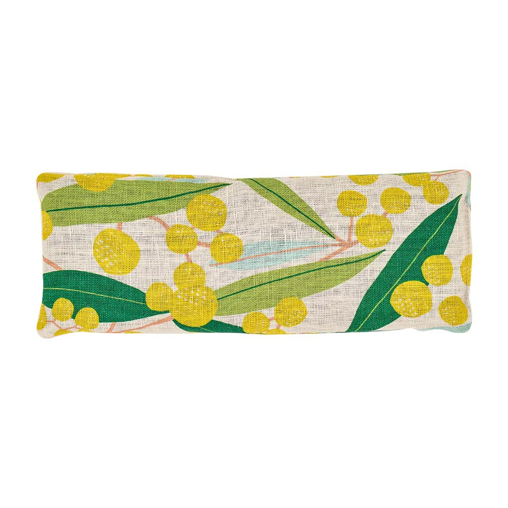 Eye rest pillow with yellow floral and green leaf pattern on a white background