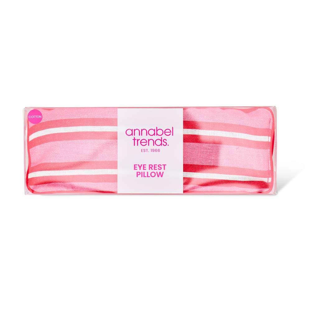 Pink striped eye rest pillow with 'annabel trends' label on a white background