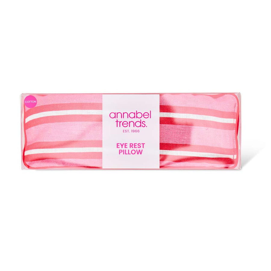 Pink striped eye rest pillow with 'annabel trends' label on a white background