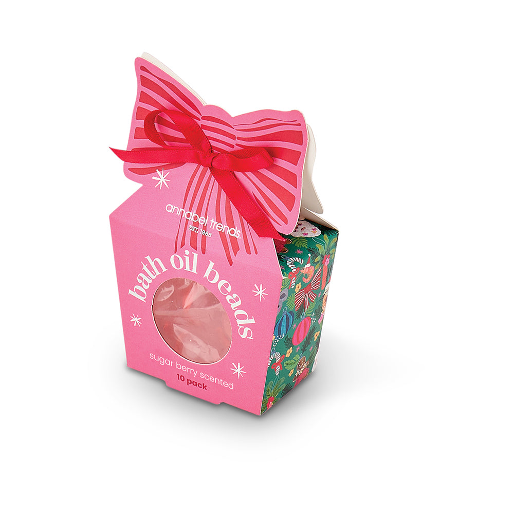 Packaged bath oil beads with a pink bow on a white background