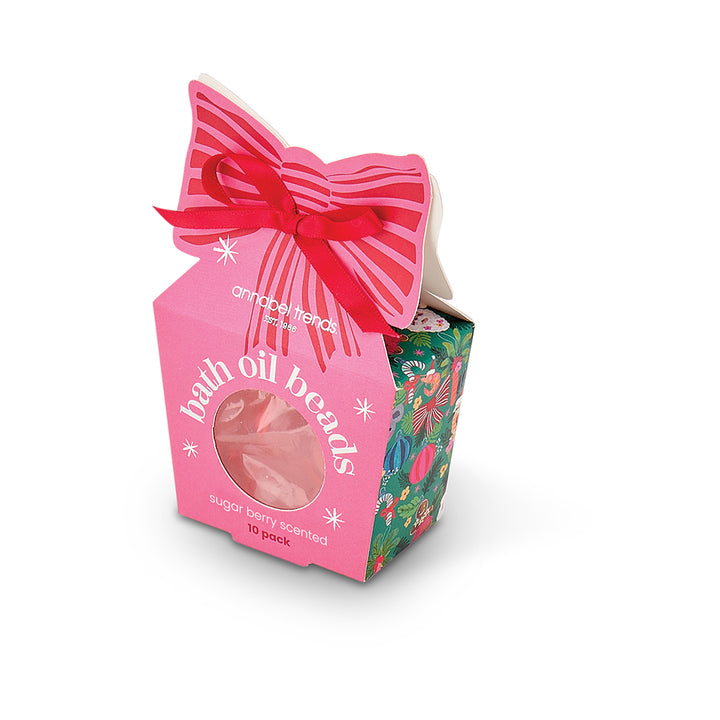 Packaged bath oil beads with a pink bow on a white background