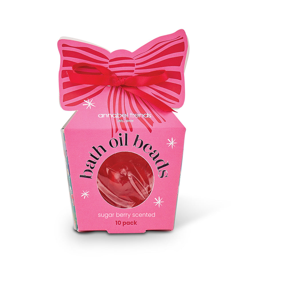 Pink packaging of bath oil beads with a bow on a white background