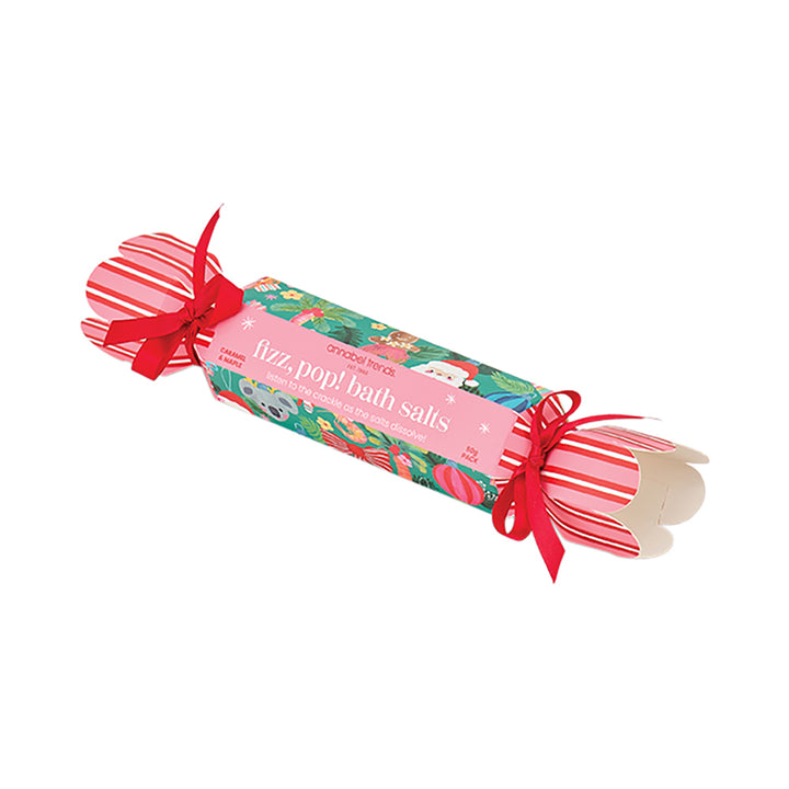 Roll of bath salts with festive packaging and red ribbons on a white background