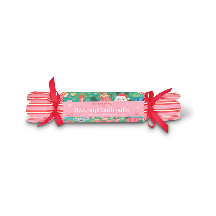 Bath salts wrapped in festive paper with a red ribbon on a white background