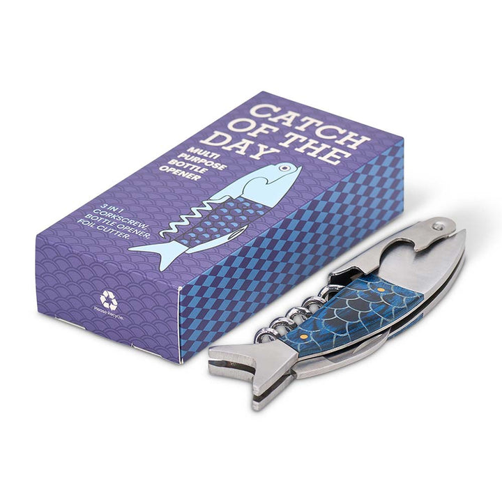 Multi-purpose bottle opener with fish design on a purple box labeled 'Catch of the Day'.