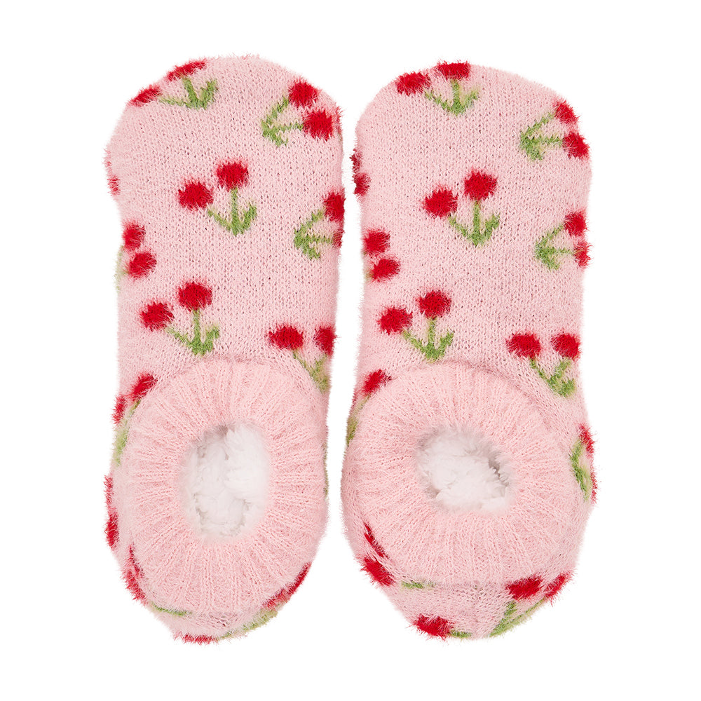 Pair of pink fuzzy booties socks with red cherry pattern on a white background