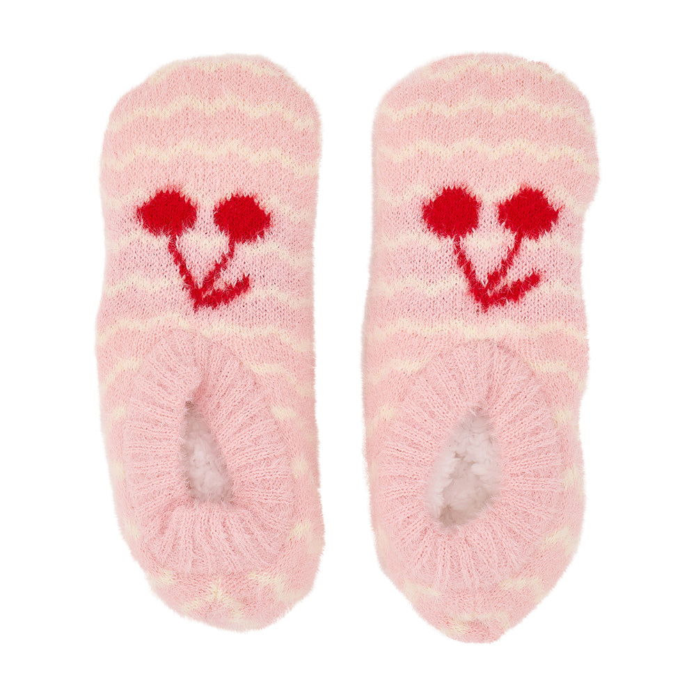 Pair of pink fuzzy socks with red cherry designs on a white background