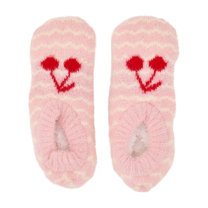 Pair of pink fuzzy socks with red cherry designs on a white background