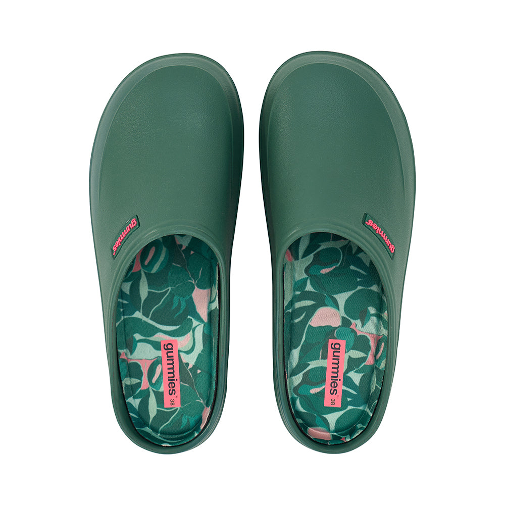 Green slip-on gummies garden shoes with floral patterned insole on a white background