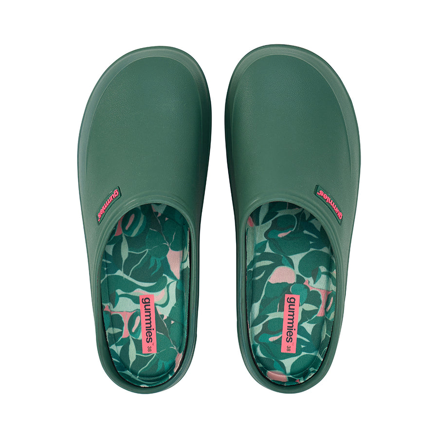Green slip-on gummies garden shoes with floral patterned insole on a white background