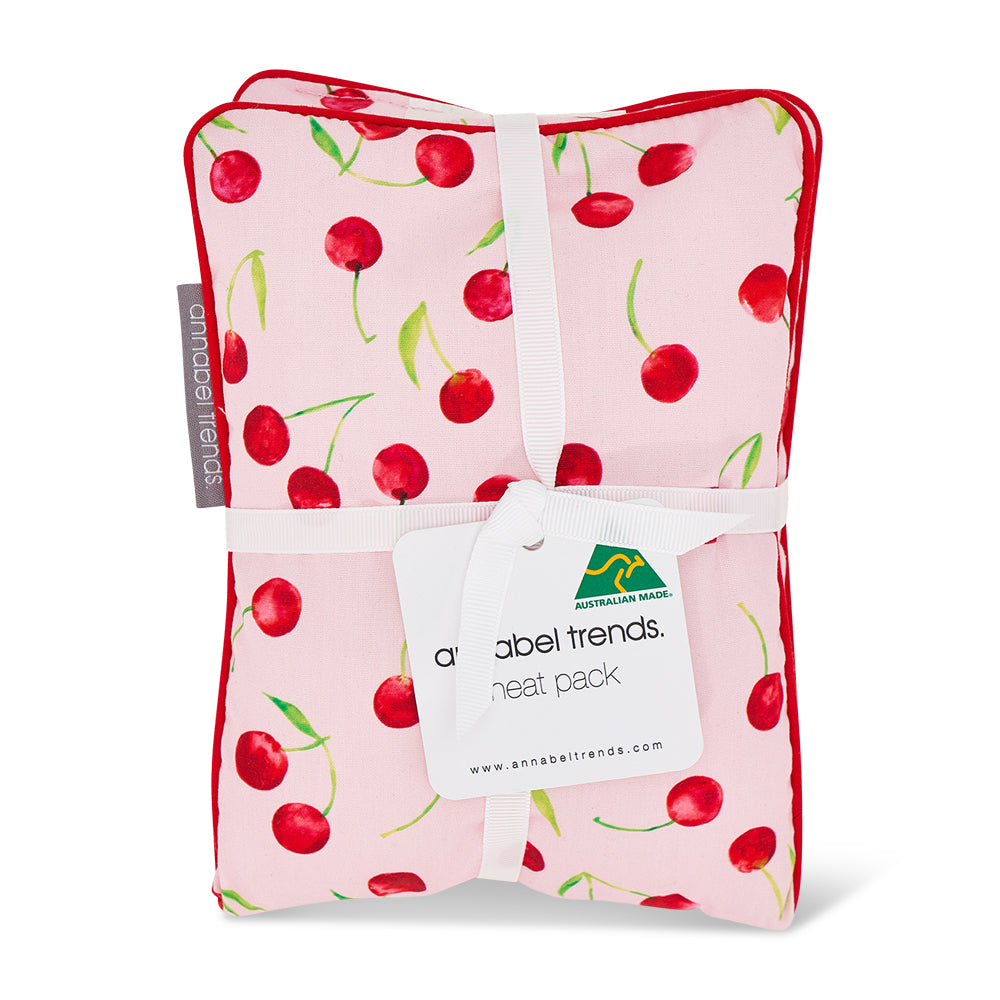 Pink heat pack with cherry pattern and 'Australian Made' tag on a white background