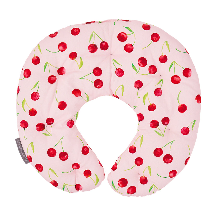Pink neck pillow with cherry pattern on a white background