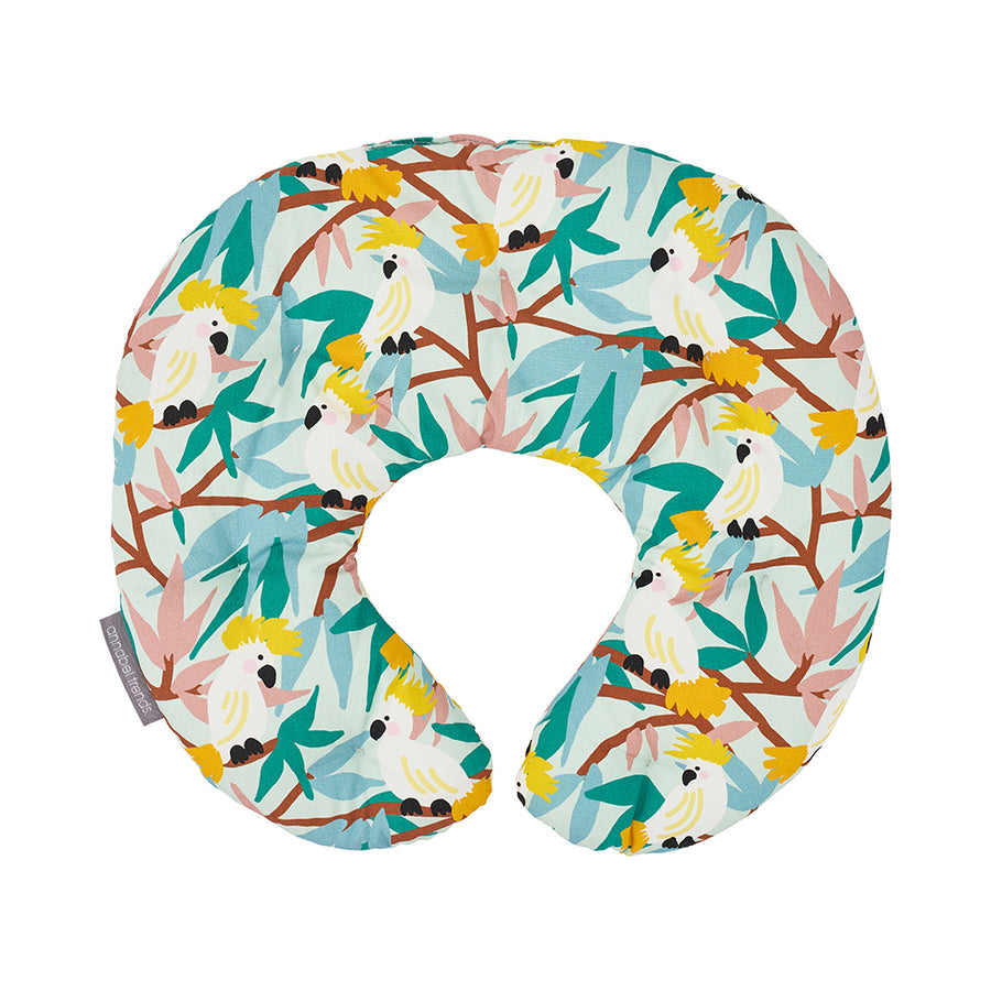 Neck pillow with a colorful bird and leaf pattern on a white background