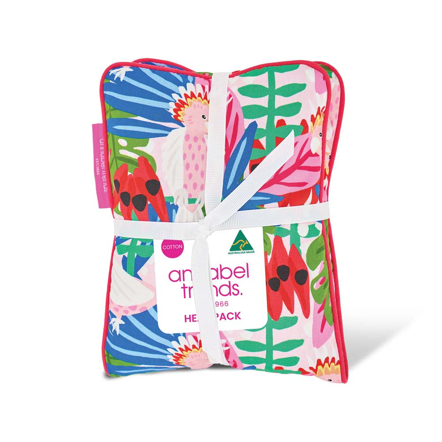 Colorful beach towel with floral patterns and a brand tag on a white background