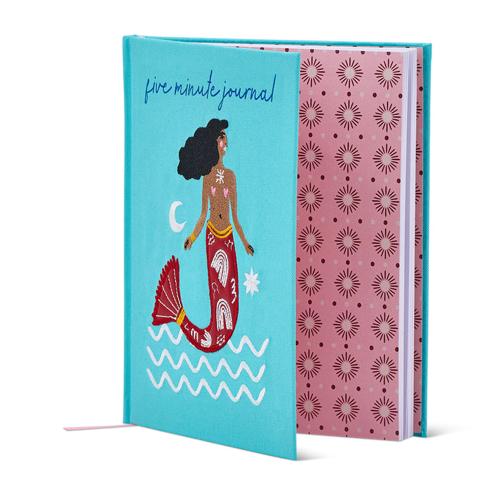 Journal with mermaid illustration on a blue cover and pink patterned back